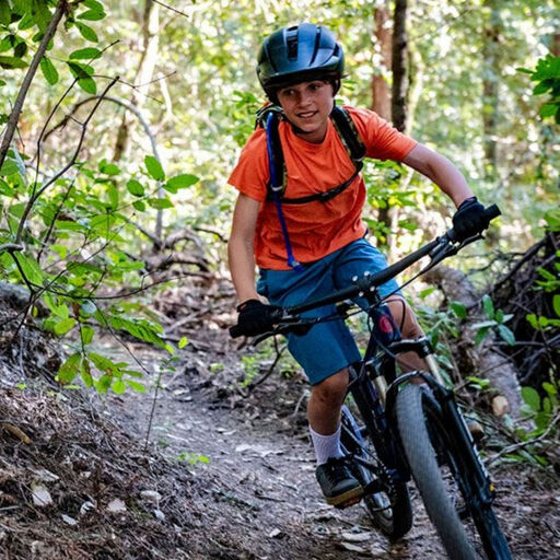 Kid on a bike in the forest