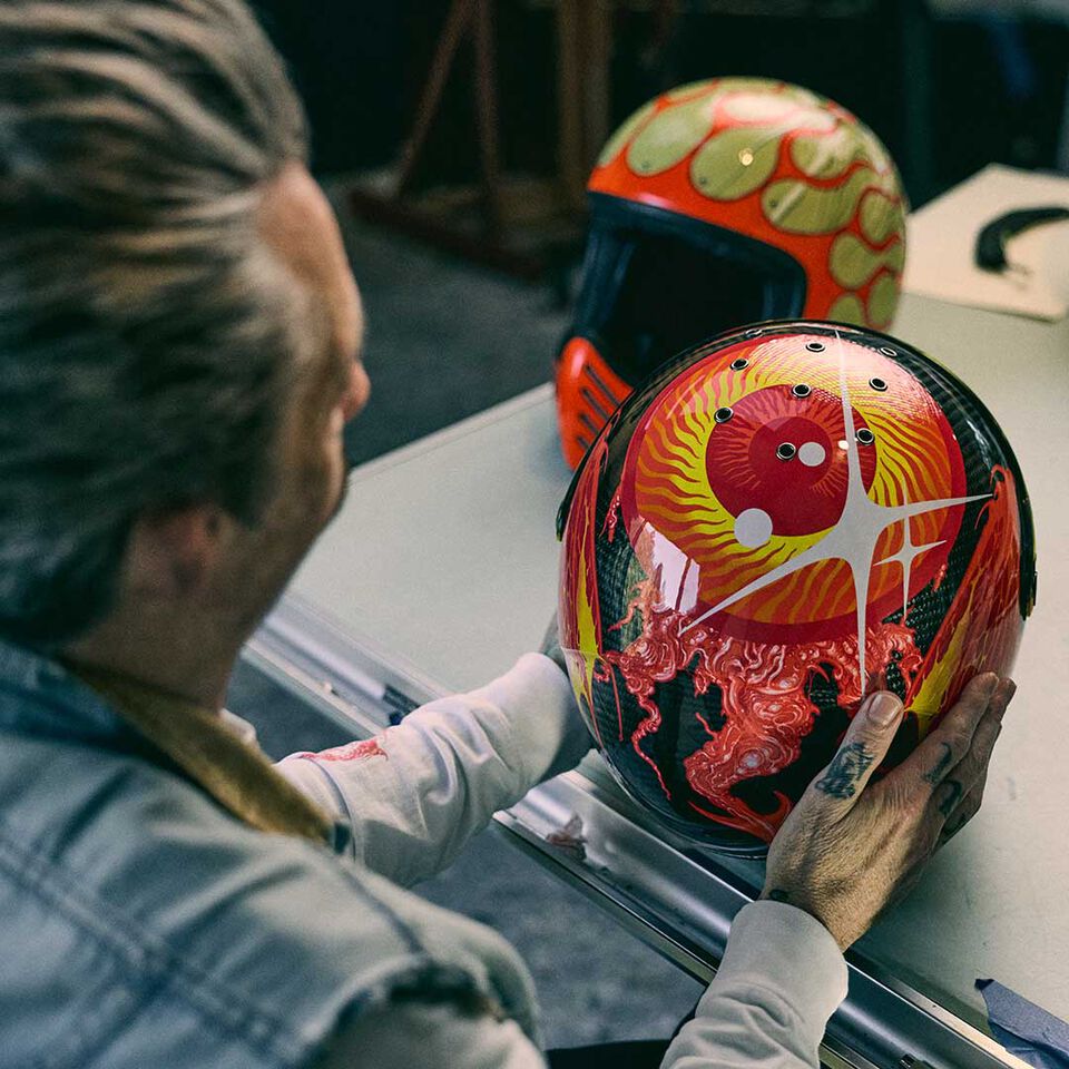 grimes holding a custom eliminator helmet
