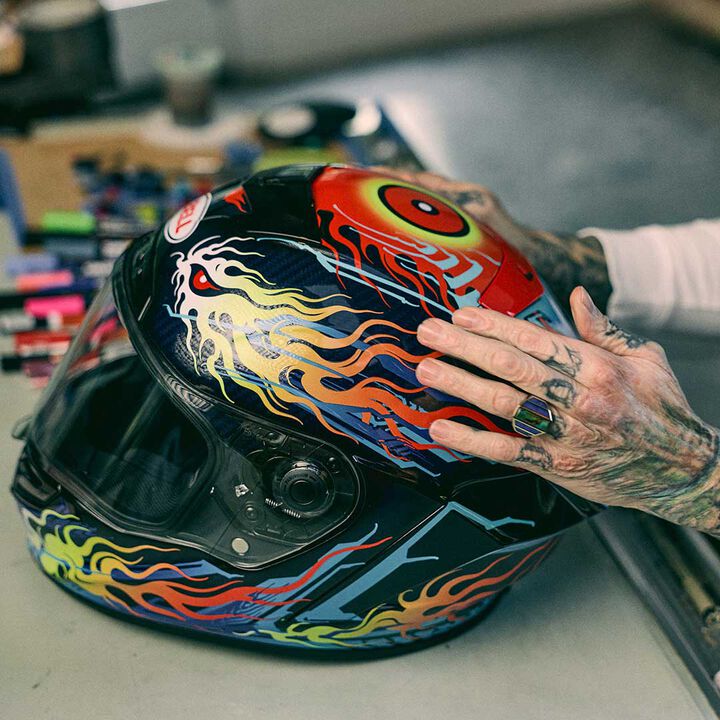 grime holding a race start helmet
