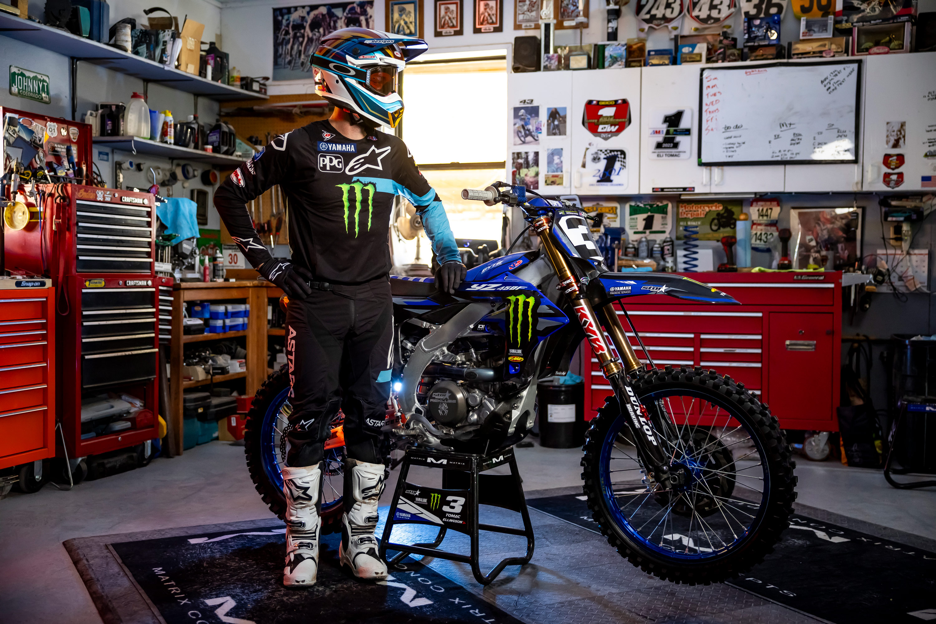 Eli Tomac with bike in garage