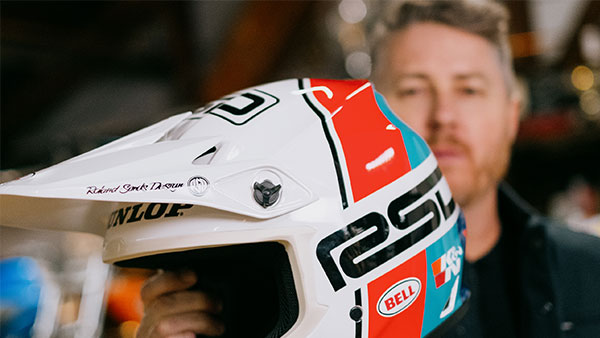 Roland Sands holding the MX-9 Mips RSD Rally helmet in front of his face